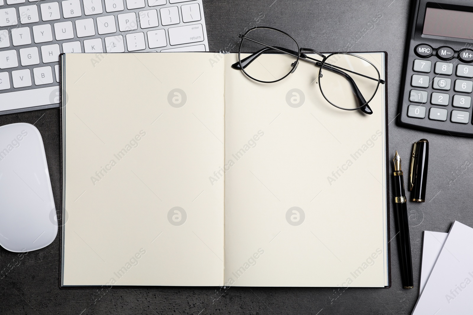 Photo of Flat lay composition with open notebook on dark grey table