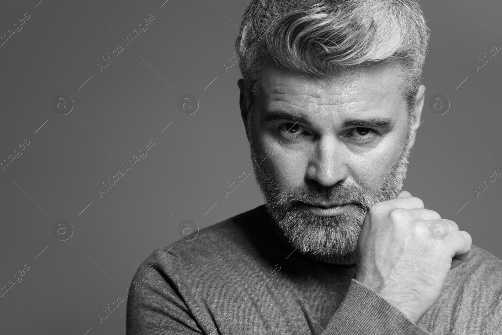 Photo of Portrait of handsome man on grey background, space for text. Black and white effect