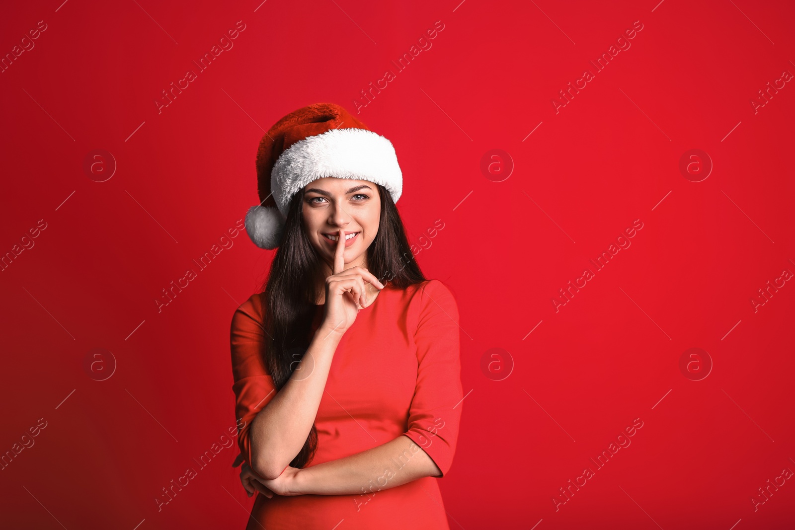 Photo of Young beautiful woman in Santa hat on color background. Christmas celebration