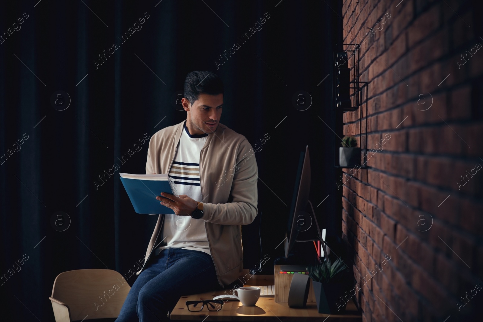 Image of Journalist with notebook at workplace in office