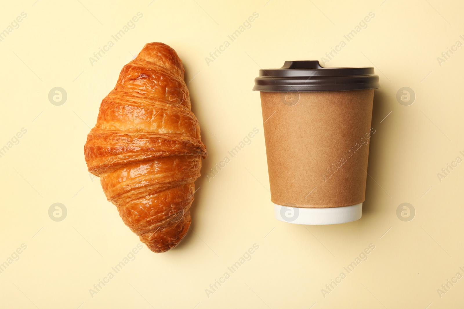 Photo of Paper coffee cup and croissant on color background, flat lay. Mockup for design