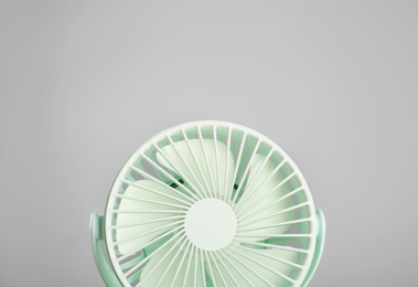 Portable fan against light grey background. Summer heat