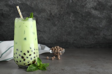 Tasty milk bubble tea with mint on light grey table. Space for text