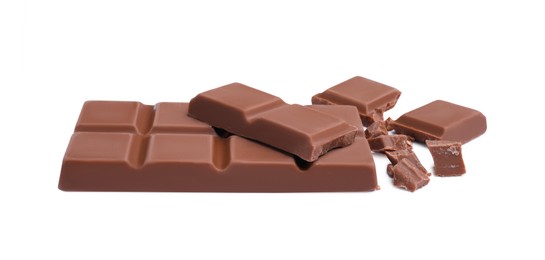 Photo of Pieces of delicious milk chocolate bar on white background