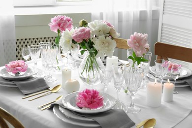 Stylish table setting with beautiful peonies in dining room