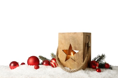 Composition with wooden Christmas lantern on snow against light grey background, space for text