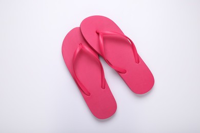 Photo of Stylish pink flip flops on white background, top view