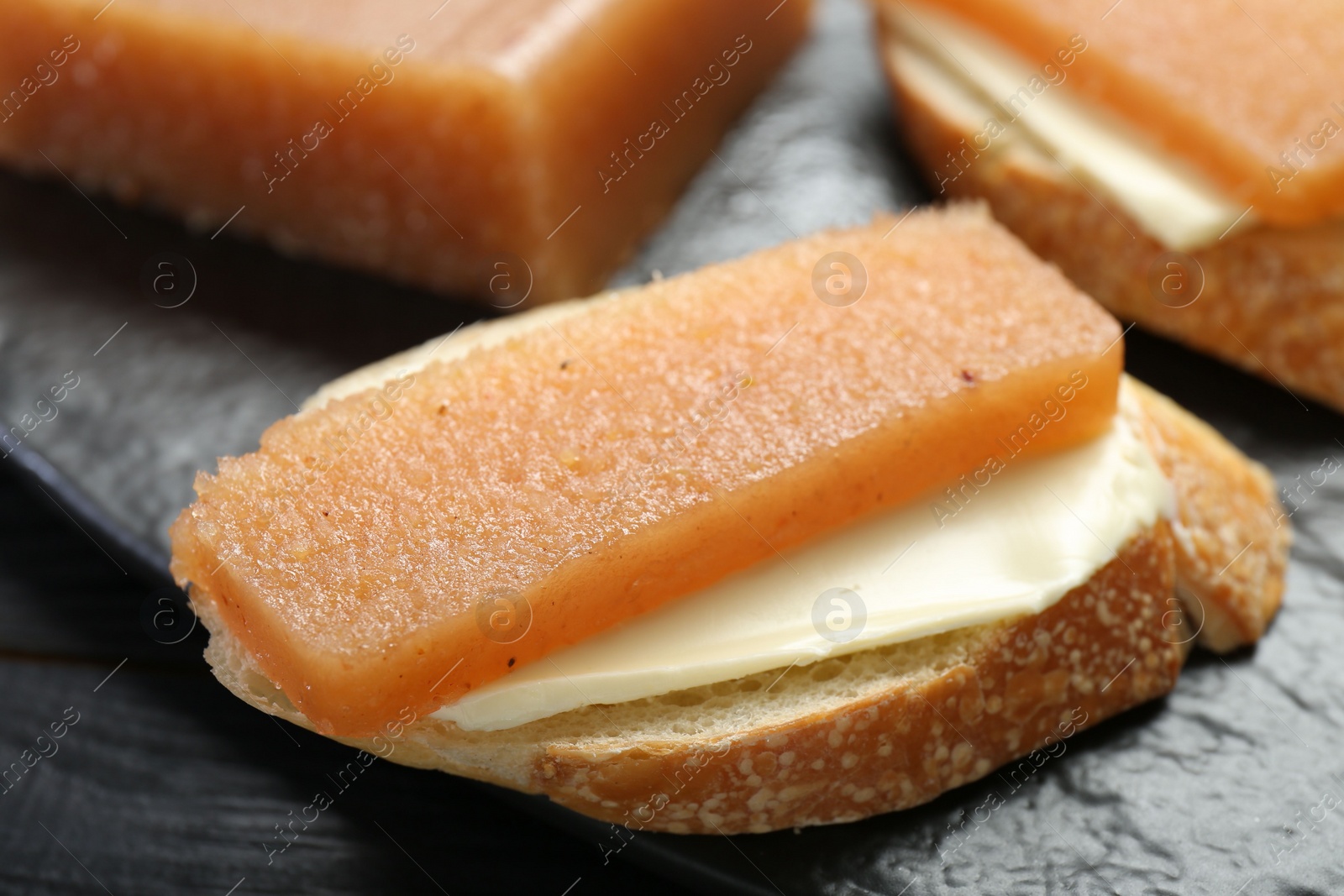 Photo of Tasty sandwich with quince paste on table, closeup