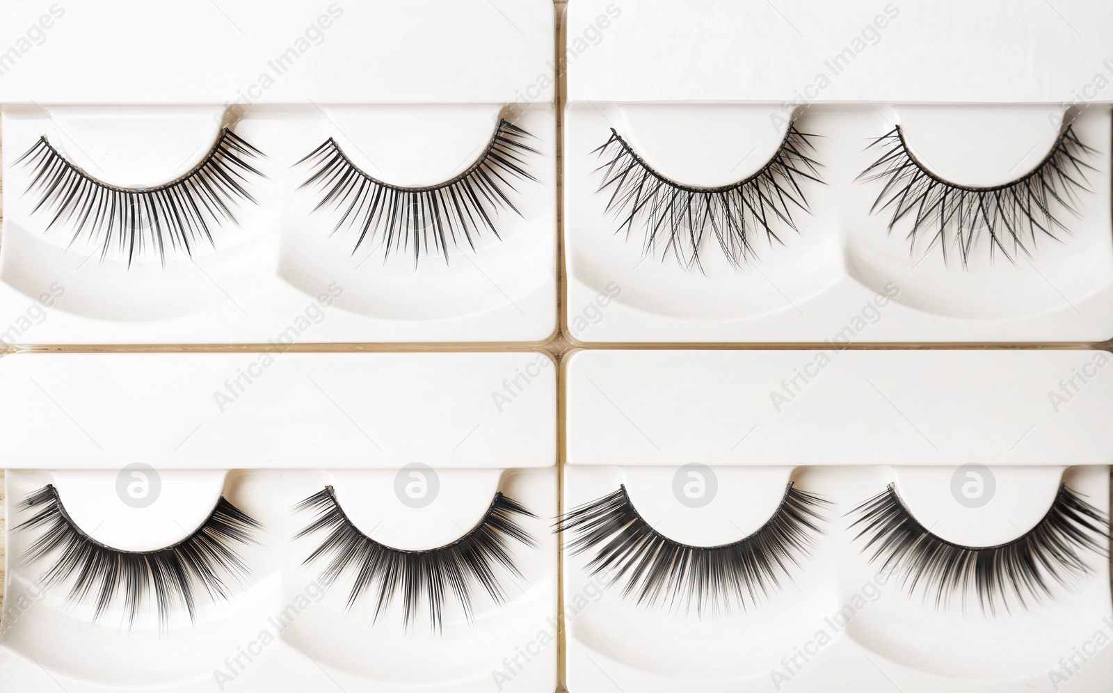 Photo of Different types of false eyelashes in packs, top view