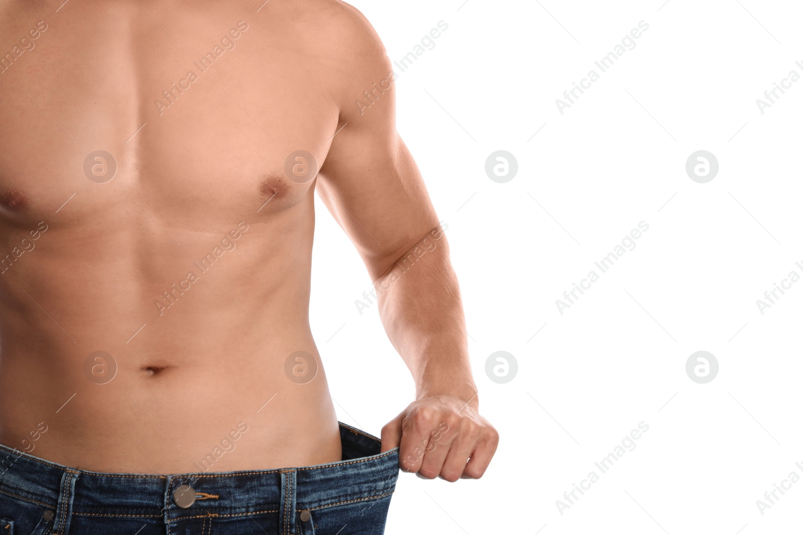 Photo of Young man with slim body in old big size jeans on white background, closeup view