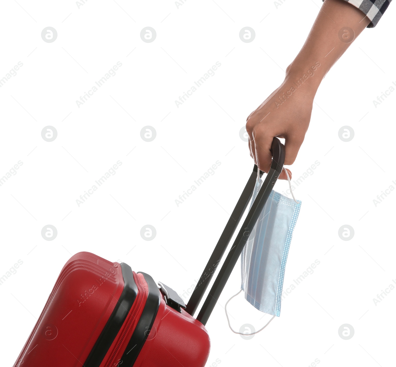 Photo of Woman with suitcase and protective mask on white background, closeup. Travelling during coronavirus pandemic