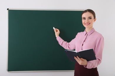 Portrait of young female teacher in classroom