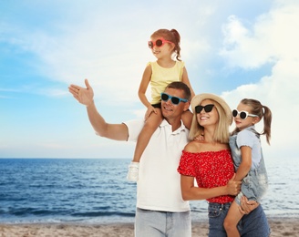 Happy family resting near sea on sunny day. Summer vacation