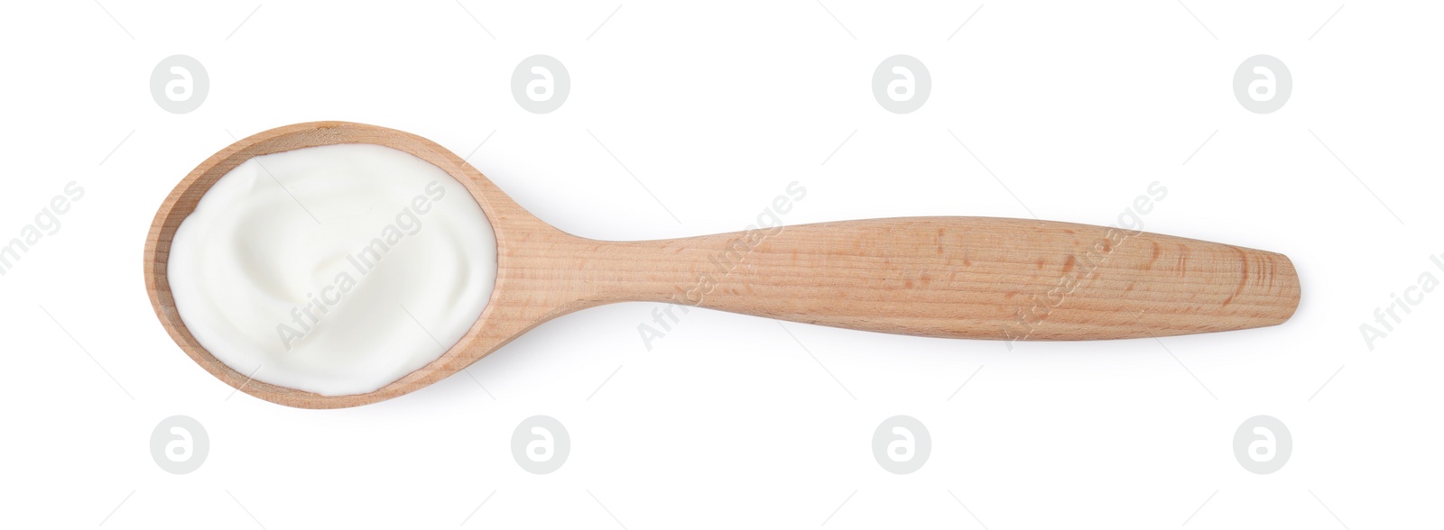 Photo of Delicious natural yogurt in wooden spoon isolated on white, top view