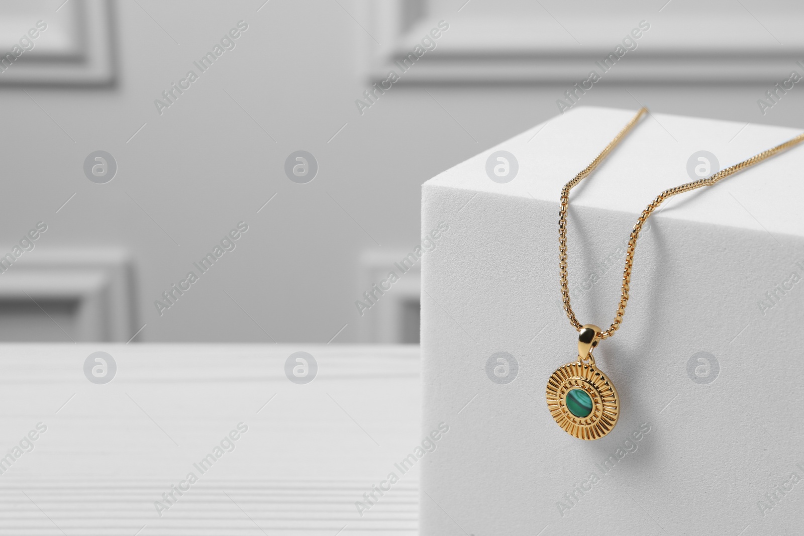 Photo of Stylish presentation of necklace on podium, space for text