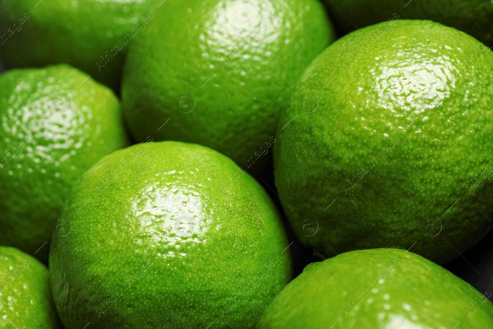 Photo of Fresh ripe green limes as background, closeup