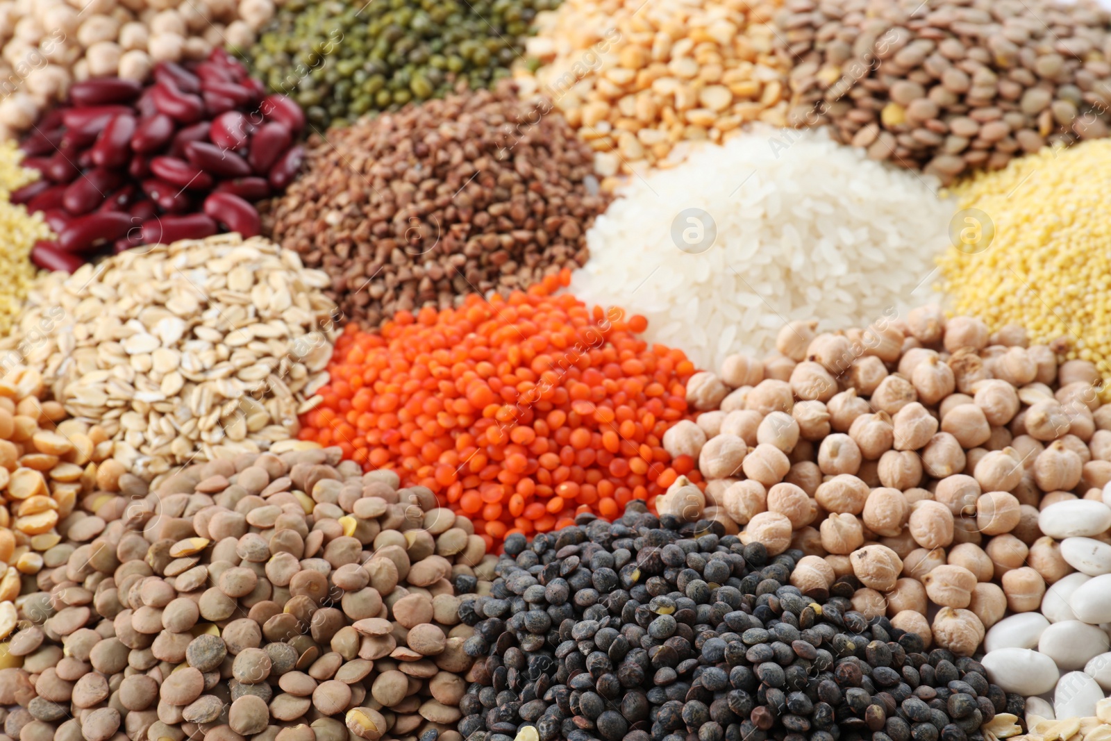 Photo of Different types of legumes and cereals as background, closeup. Organic grains