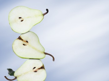 Image of Cut fresh ripe pears on blue gradient background, space for text