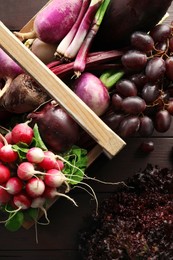 Different fresh ripe vegetables on wooden table, top view