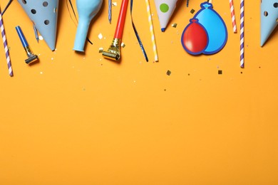 Photo of Flat lay composition with party items on orange background, Space for text