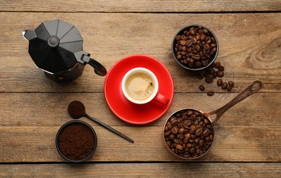 Photo of Flat lay composition with coffee grounds and roasted beans on wooden table