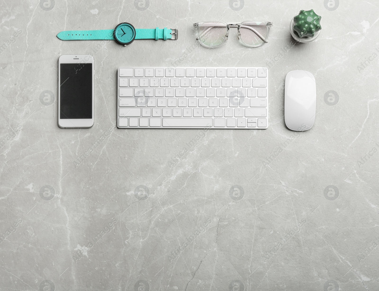 Photo of Flat lay composition with smartphone, keyboard and space for text on grey background. Blogger's workplace