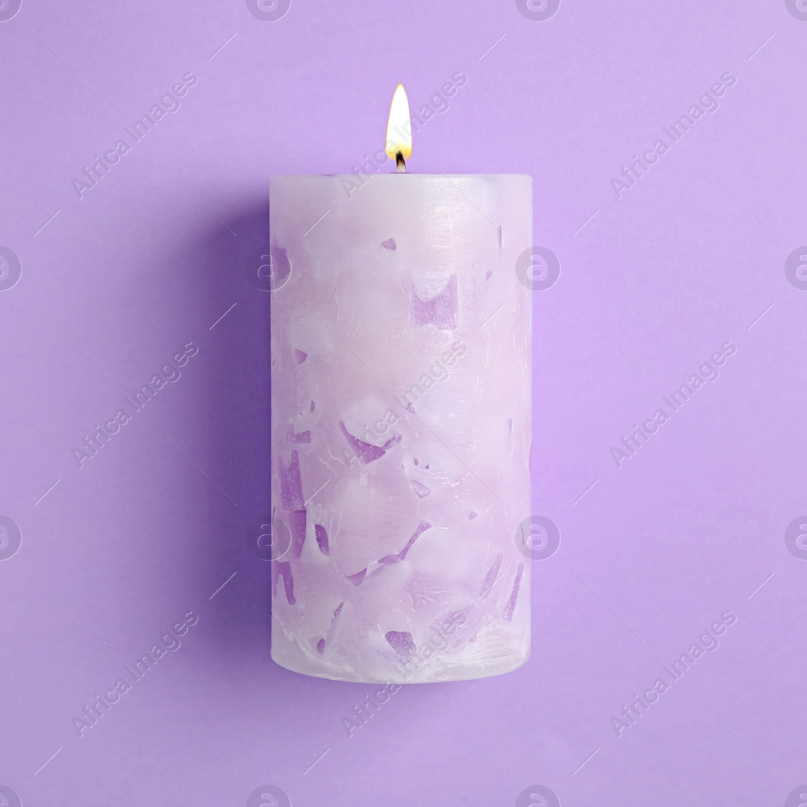 Photo of Alight scented wax candle on color background