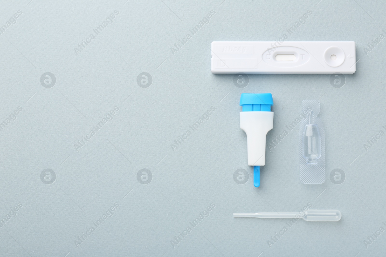 Photo of Disposable express test kit on light blue background, flat lay. Space for text