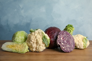 Different sorts of cabbage on wooden table