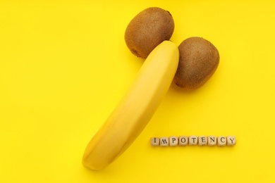 Photo of Fruits symbolizing male sexual organ and word IMPOTENCY on yellow background, flat lay