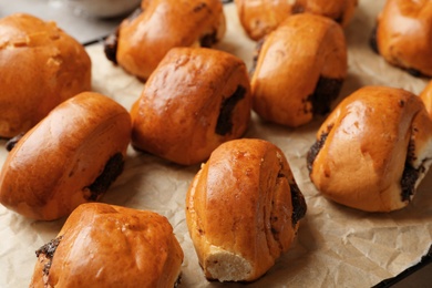 Tasty poppy seed buns on baking paper