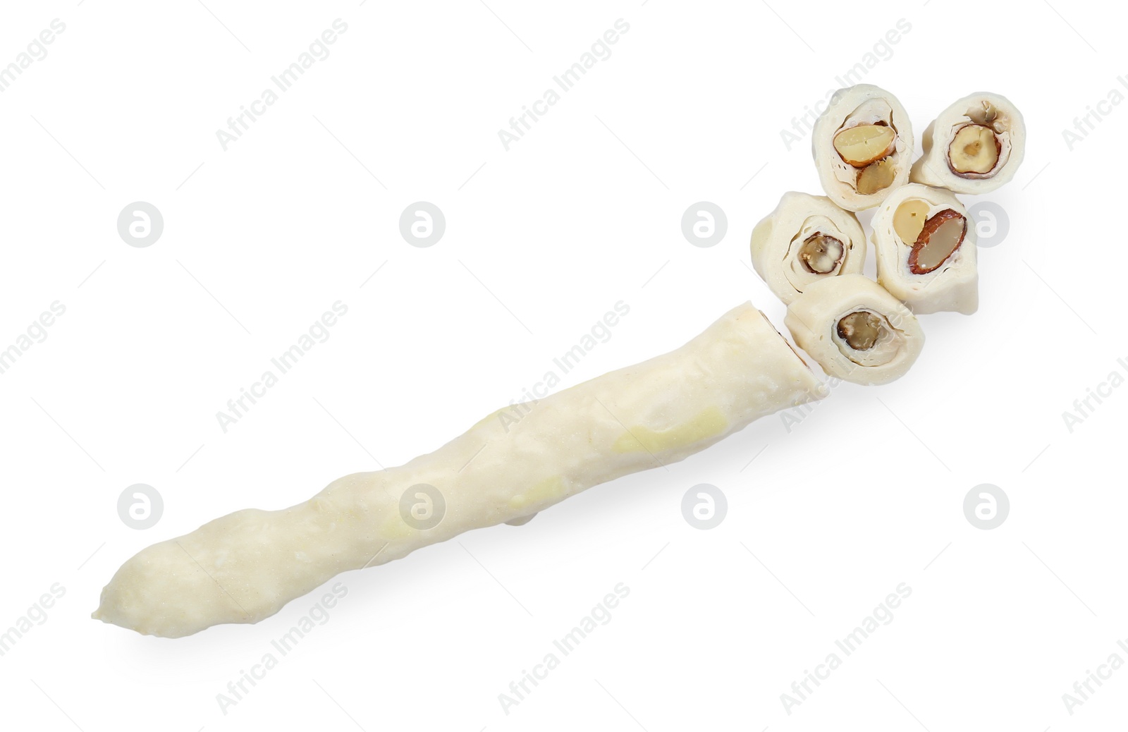 Photo of One cut churchkhela with nuts isolated on white, top view