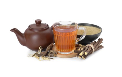 Photo of Aromatic licorice tea in cup, teapot, dried sticks of licorice root and powder isolated on white