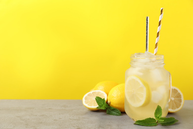 Photo of Natural freshly made lemonade with mint on light grey table. Summer refreshing drink