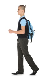 Photo of Full length portrait of teenage boy in school uniform with backpack on white background