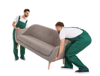 Photo of Young workers lifting sofa isolated on white. Moving service