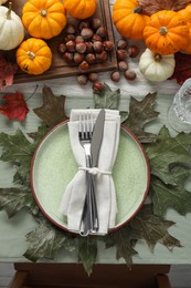 Happy Thanksgiving day. Beautiful table setting with autumn leaves, hazelnuts and pumpkins, flat lay