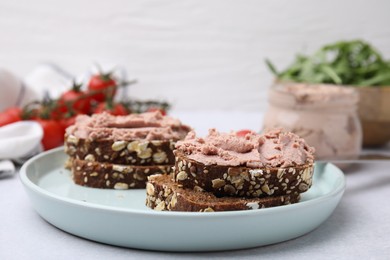 Photo of Delicious liverwurst sandwiches served on white table, closeup