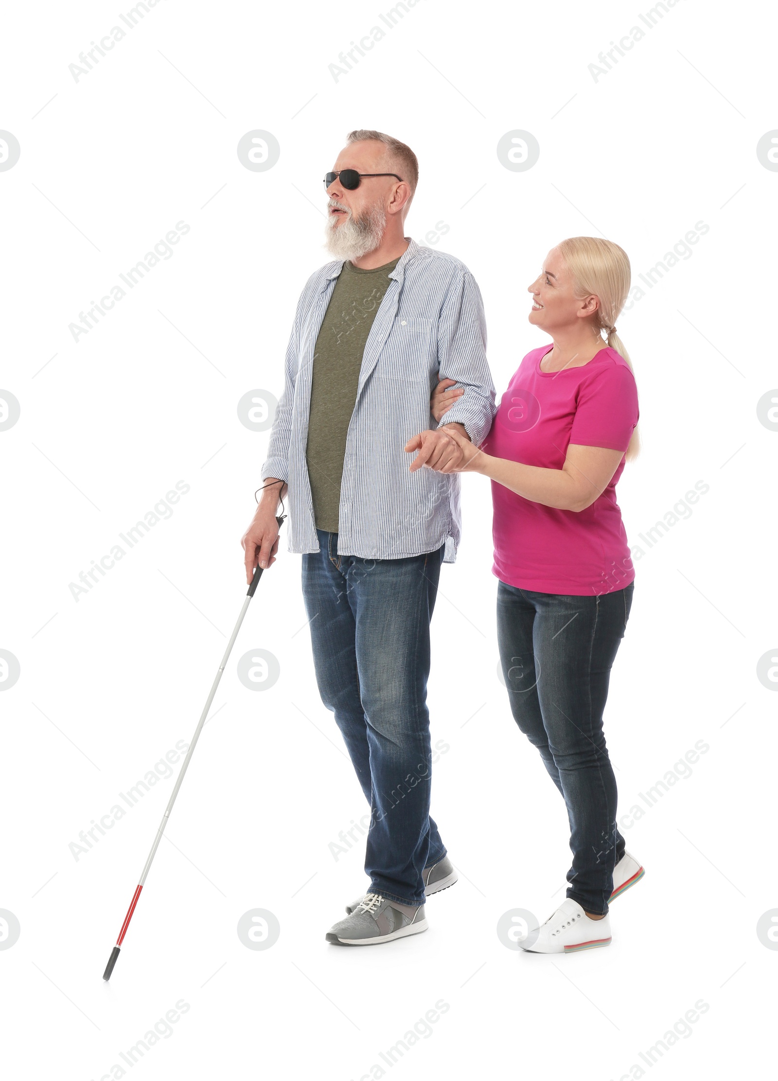 Photo of Mature woman helping blind person with long cane on white background