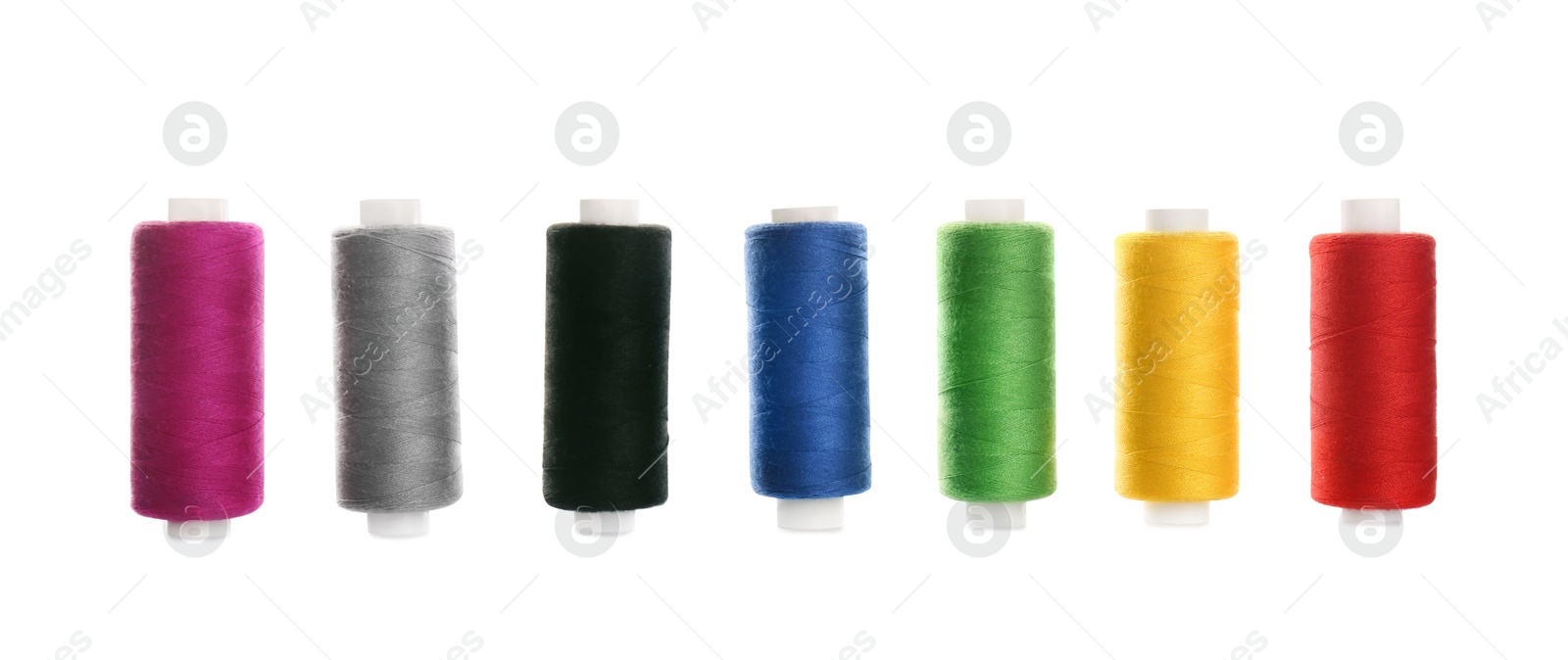 Photo of Set of colorful sewing threads on white background