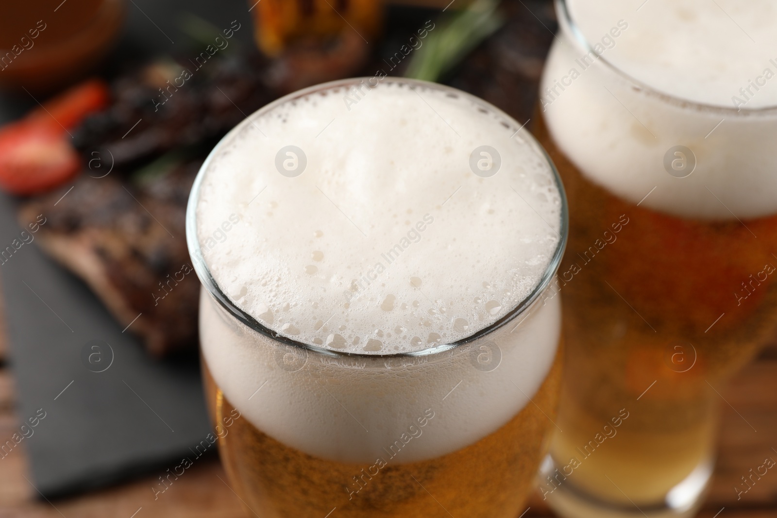 Photo of Glasses of tasty beer on table, closeup view
