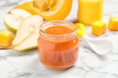 Photo of Healthy baby food and fresh ingredients on white marble table