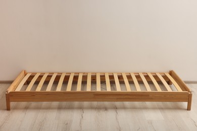 Photo of Wooden bed frame on floor in room