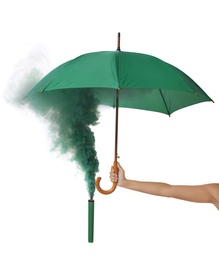Photo of Woman holding umbrella and green smoke bomb on white background, closeup