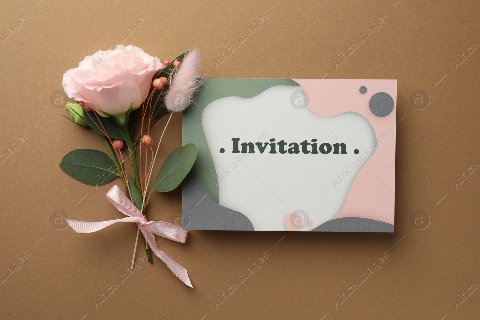 Photo of Card with word Invitation and beautiful flowers on beige background, flat lay