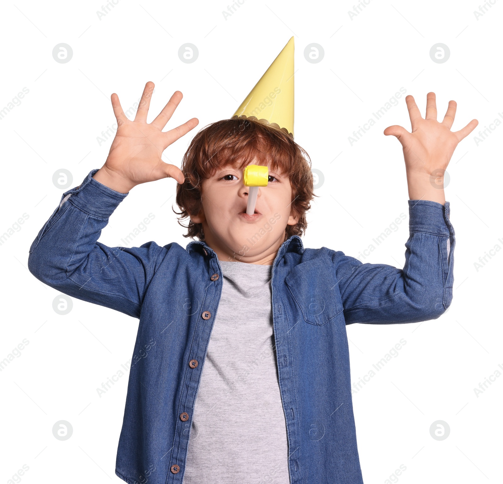 Photo of Birthday celebration. Cute little boy in party hat with blower on white background