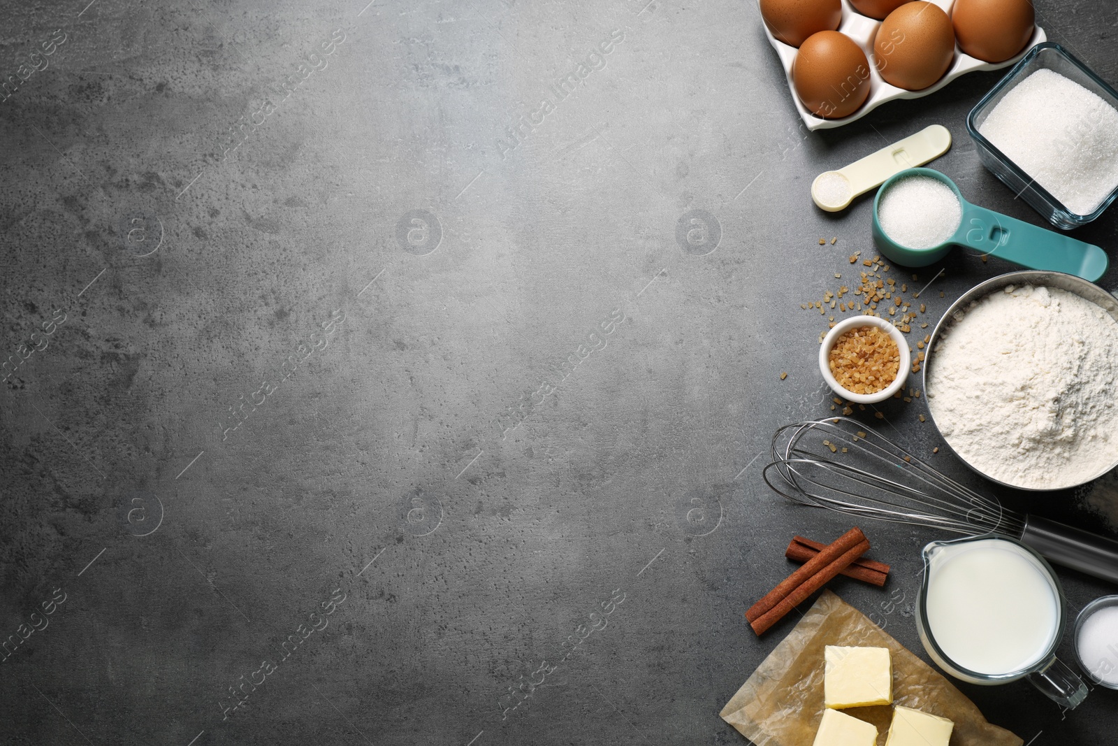 Photo of Flat lay composition with fresh ingredients for delicious homemade cake on grey table. Space for text