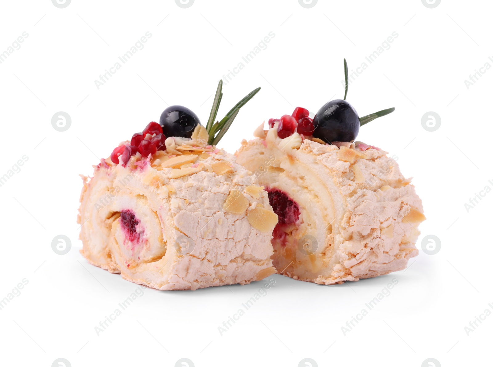 Photo of Slices of tasty meringue roll with jam, pomegranate seeds and rosemary isolated on white