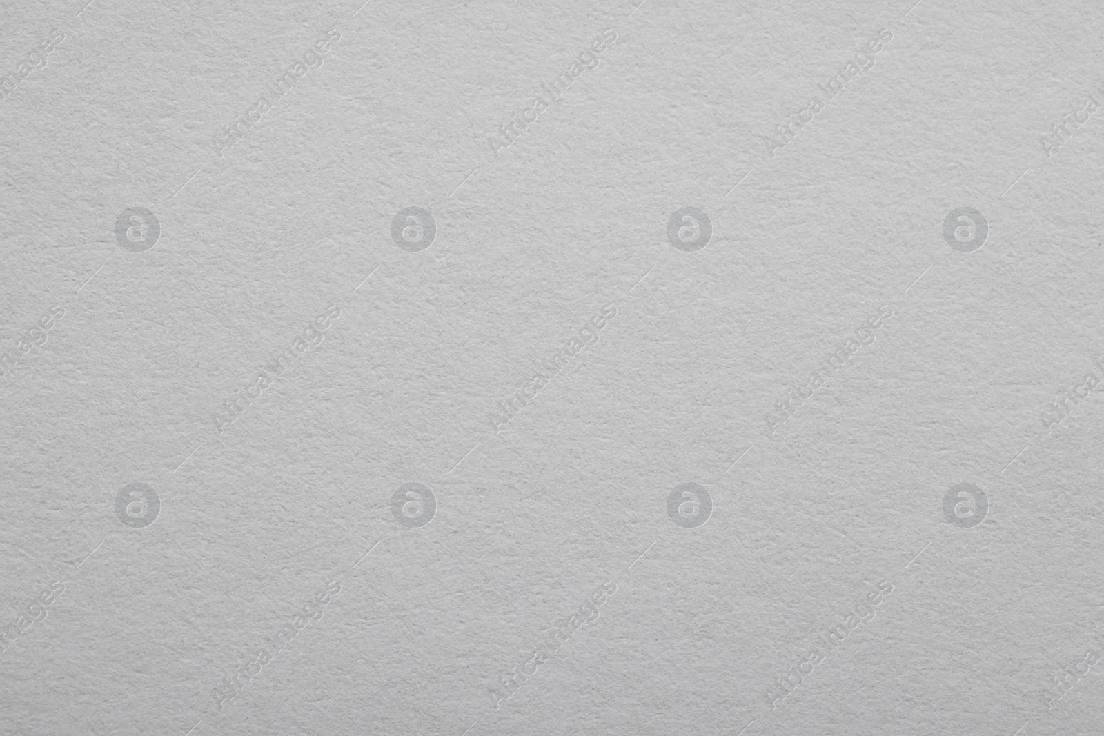 Photo of Texture of light grey paper sheet as background, top view