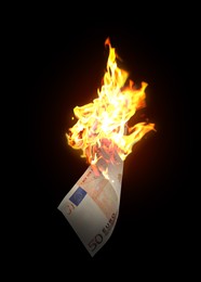 Image of One euro banknote burning on black background